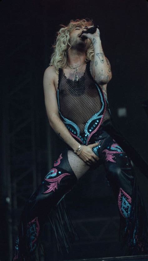 a woman with long hair and tattoos on stage