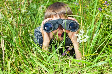 Child looking through binoculars Stock Photo | Adobe Stock