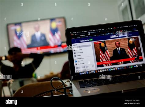 Prime Minister Muhyiddin Yassin's speech on a laptop screen in Kuala Lumpur.Malaysian Prime ...