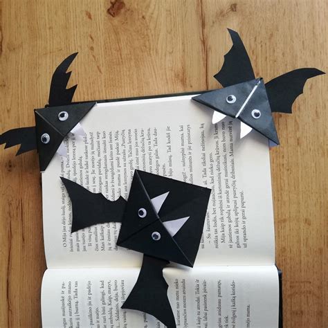 an open book with some paper bats on it