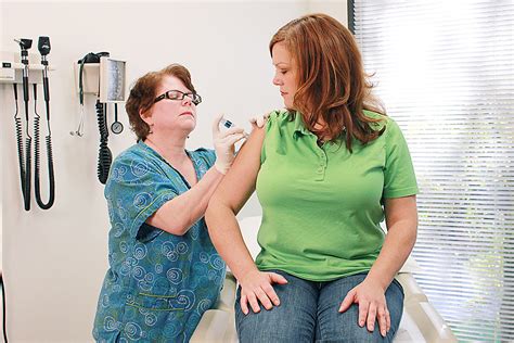 Vaccine | Free Stock Photo | A nurse giving a woman a flu vaccine shot ...