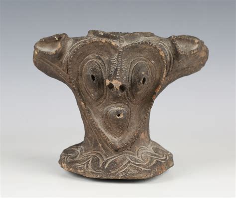 A pottery model of a stylized mask, probably Papua New Guinea, modelled ...