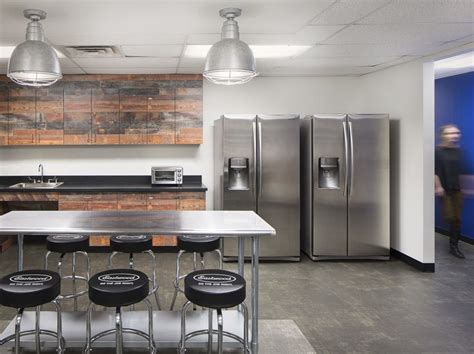 Modern break room with branded chairs, metal table and blue walls on a background. Great ...