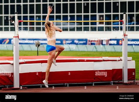 woman athlete jumping high jump in summer athletics championships ...