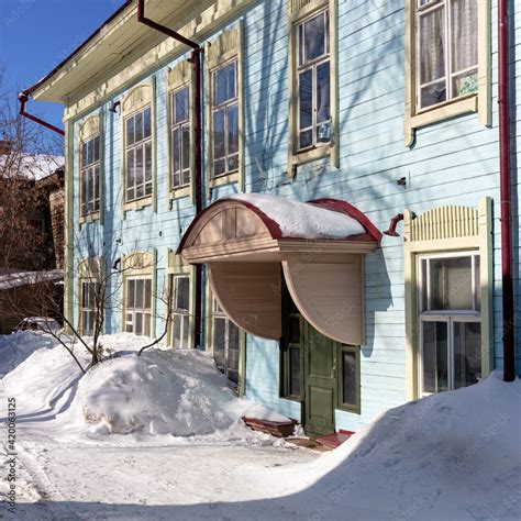 Old wooden houses under the snow. Russia. Siberia. Winter. The city of ...