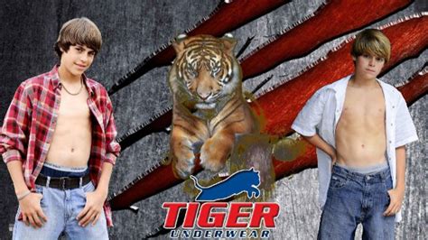 two young men standing next to each other in front of a tiger wallpaper ...