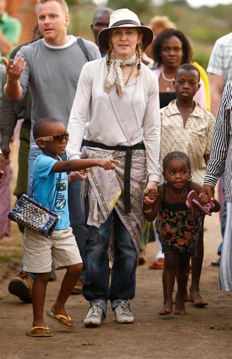 Madonna goes back to school in Malawi with her adopted children David ...