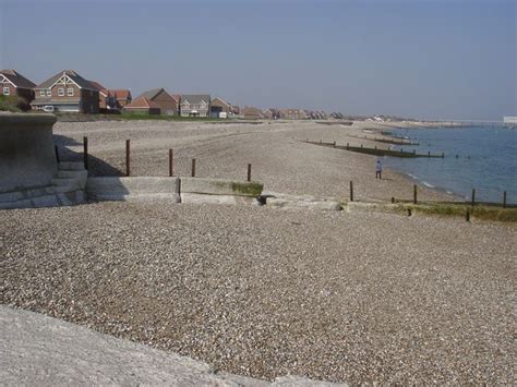 a beach with houses and water in the background