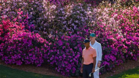Masters champion Tiger Woods looks on from the No. 13 green with caddie Joe LaCava during a ...