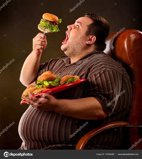 Fat man eating fast food hamberger. Breakfast for overweight person. ⬇ ...