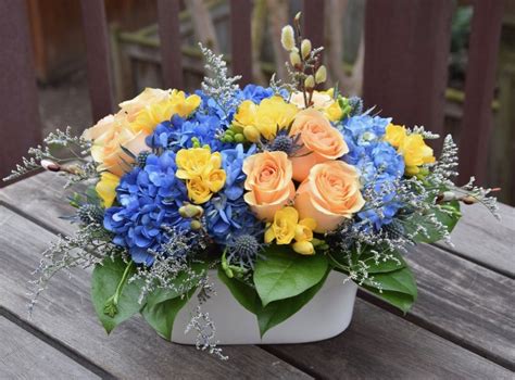 Flower arrangement with blue hydrangeas, yellow freesia, roses, green salal. | Flower ...