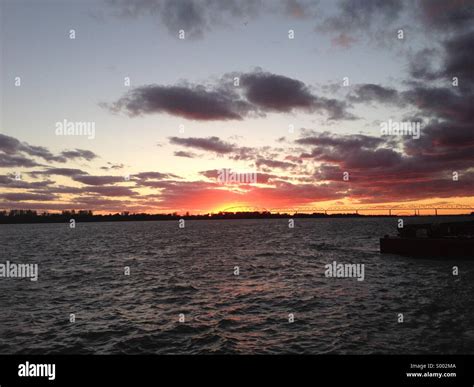 Sunrise over river Stock Photo - Alamy