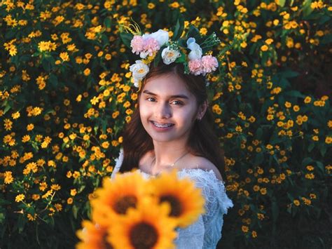 Premium Photo | Portrait of smiling woman with red flowers