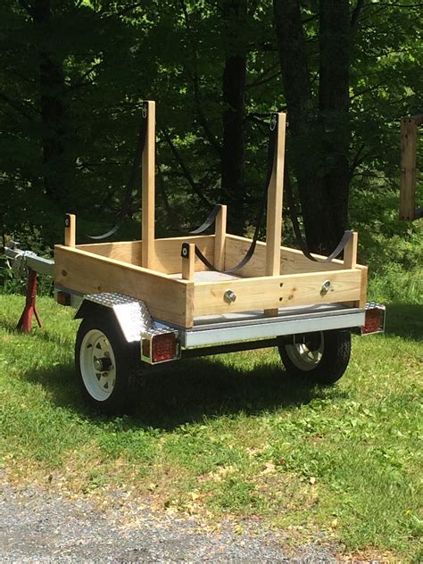 DIY utility trailer conversion to haul kayaks. Straps suspend boats ...