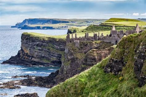 Dramatically poised on a cliff overlooking the sea in Northern Ireland ...