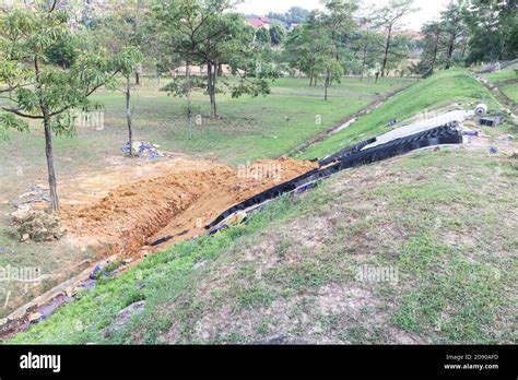 Slope erosion control grids, sheets and earth on steep slope Stock Photo - Alamy