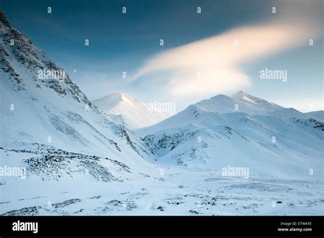 Moon Over the Snow Covered Mountains Stock Photo - Alamy