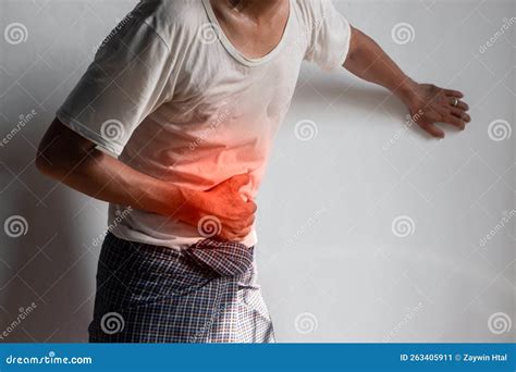 Asian Man Suffering from Upper Abdominal Pain. it Can Be Caused by Stomach Ache, Enteritis ...