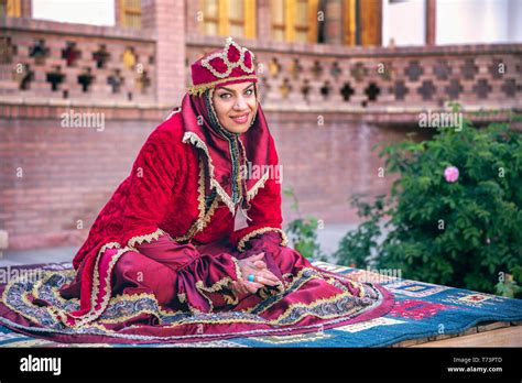 Iranian woman in red traditional dress Stock Photo - Alamy