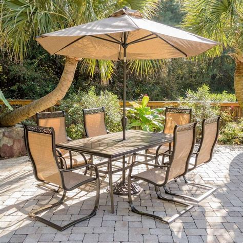 Hanover Outdoor Monaco 7-Piece Tile-Top Dining Set with Sling C-Spring Chairs and Umbrella w ...