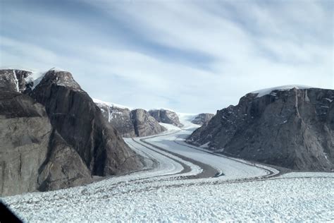 A small glacier with well-defined medial moraines joins the trunk of ...