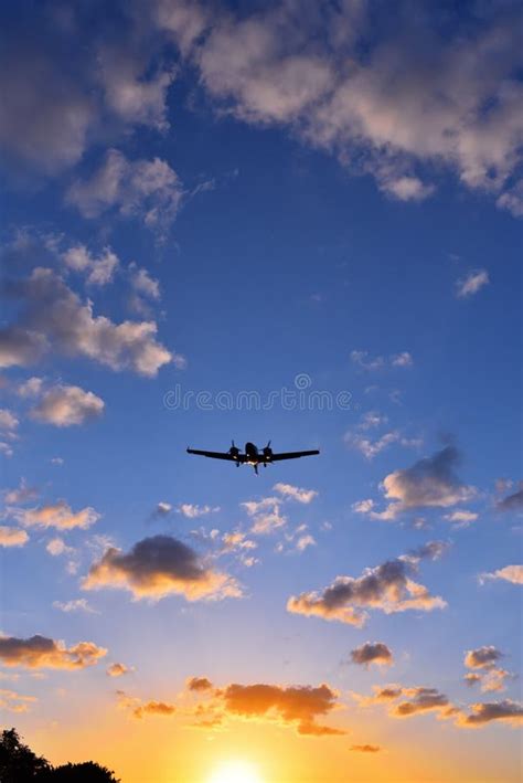 A plane landing at sunset stock image. Image of flight - 243043249