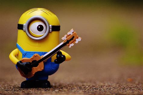 Royalty-Free photo: Shallow focus photography of Stuart The Minion playing guitar display figure ...