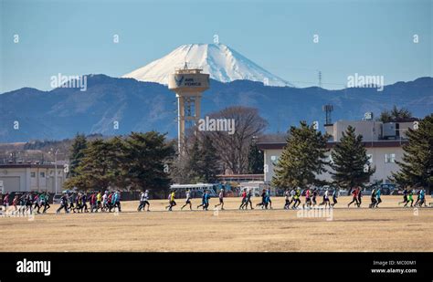 Competitors run around the Yokota Air Base, Japan, Jan. 14, 2018 ...