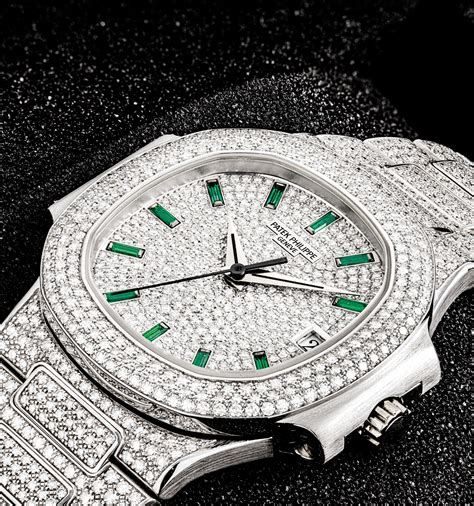 PATEK PHILIPPE. A VERY RARE AND EXCEPTIONAL 18K WHITE GOLD, DIAMOND AND EMERALD-SET AUTOMATIC ...