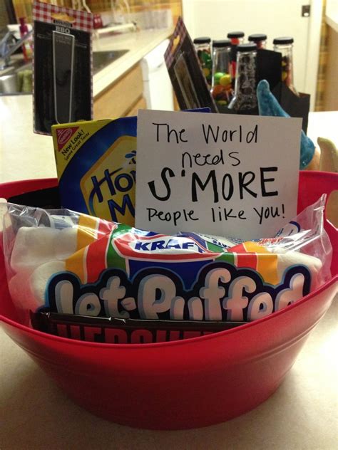 a bowl filled with candy sitting on top of a counter next to a sign ...