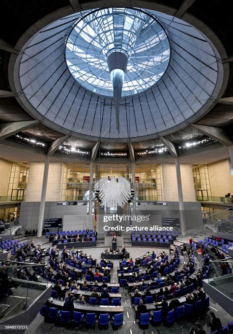 MPs sit in the plenary chamber of the Bundestag. The agenda includes ...