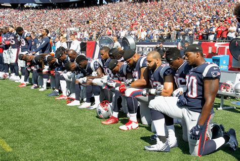 American Football Player Kneeling