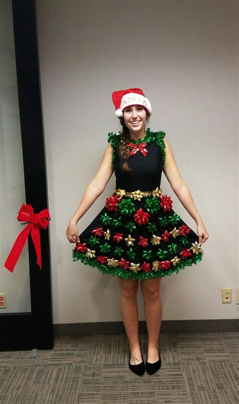 a woman in a christmas dress and santa hat