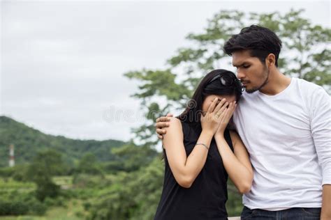 Young Handsome Boyfriend Hugging His Girlfriend, she Was Sad and Upset ...