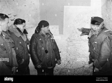 RAF Bomber Command 1940 A Wellington bomber crew studies a wall-mounted ...