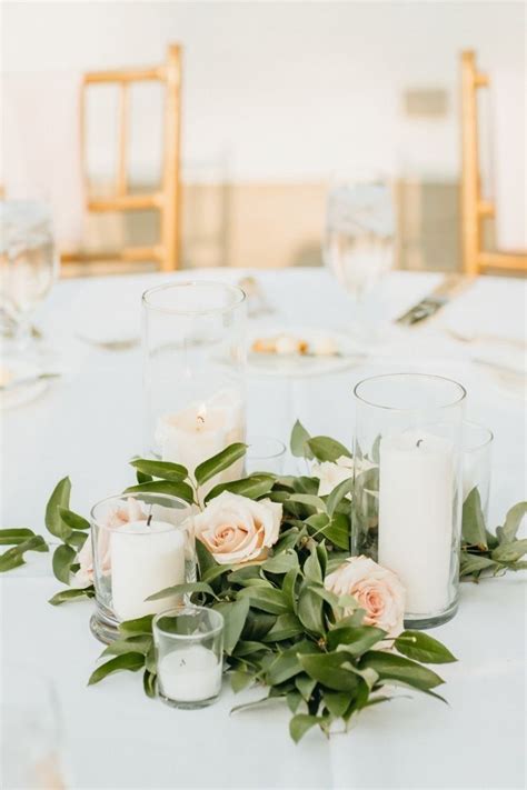 Pillar Candle Centerpieces | Candle wedding centerpieces, Candle greenery centerpiece, Greenery ...