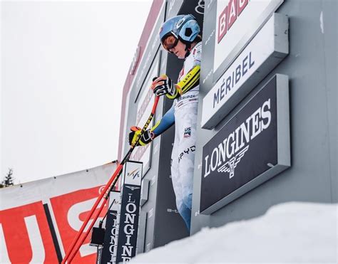 a man on skis climbing up the side of a building