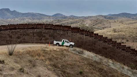 Smugglers help migrants scale border wall ‘using $5 ladders’