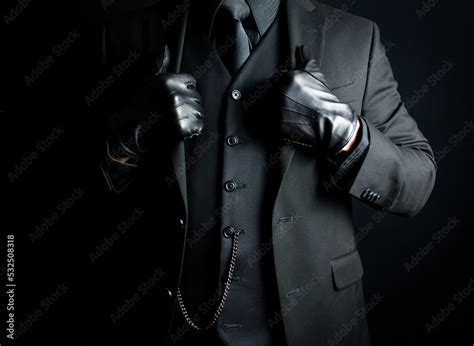 Foto de Portrait of Mysterious Man in Black Suit and Gloves. Concept of Mafia Hitman or Hotel ...