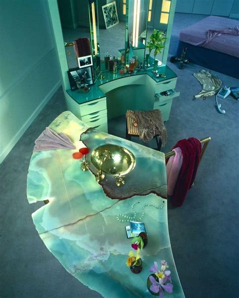 a bedroom with a vanity, mirror and other items on the floor in front of it