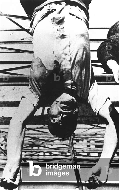 Image of The body of Benito Mussolini, hung from a dispenser in by ...