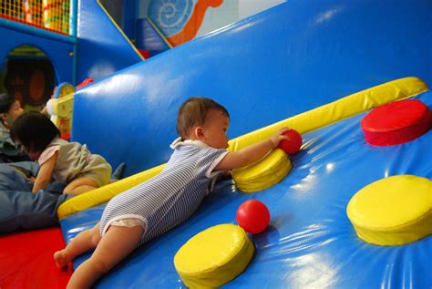 Isaac reaches for a red ball on the padded slope | Crocs Pla… | Flickr