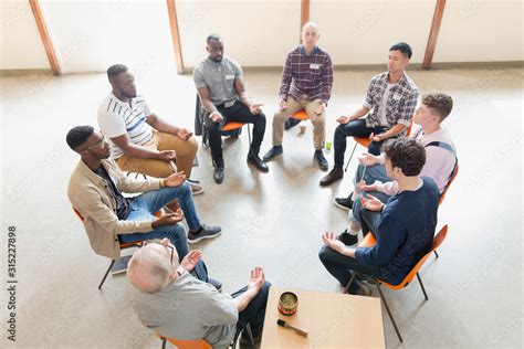 Men praying in circle in prayer group Stock Photo | Adobe Stock