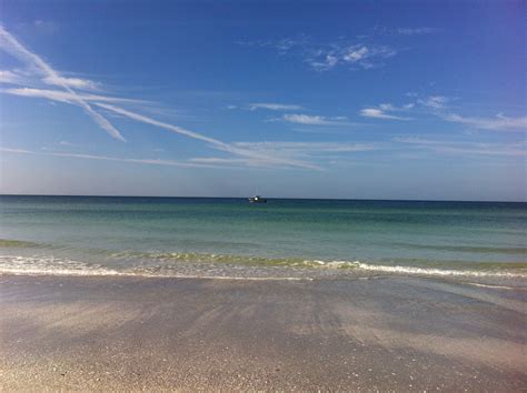 a boat is out in the ocean on a sunny day