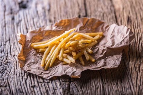 Potato Fries. Gold Potato Fries with Salt and Dry Herbs on Wooden Board Stock Image - Image of ...