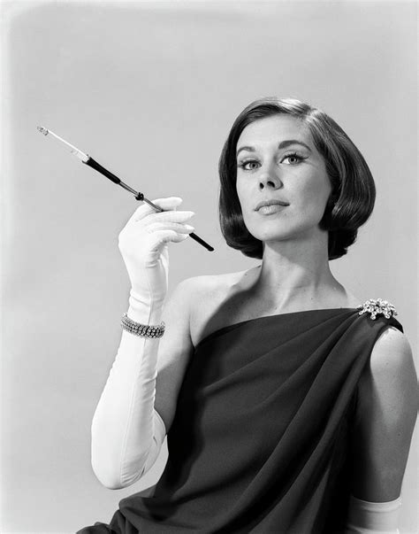 1960s Formally Elegantly Dressed Young Woman Arrogant Expression Holding Long Cigarette Holder ...