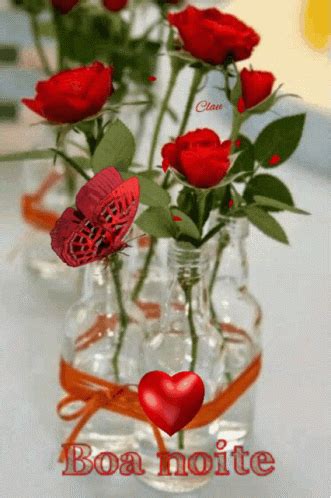 three vases with red roses in them and a heart on the bottom one that says bon noite