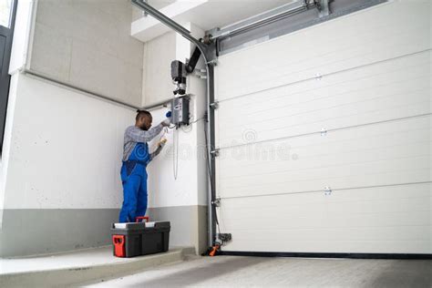 Garage Door Installation and Repair at Home. Contractor Man Stock Photo ...