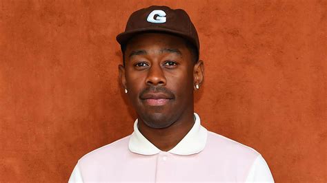 Tyler The Creator Is Wearing Light Pink White Dress And Brown Cap ...