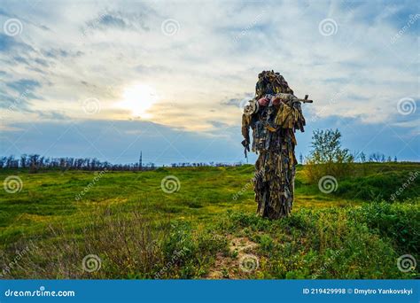 Airsoft Player in Camouflage Military Uniform Holds a Rifle in His ...